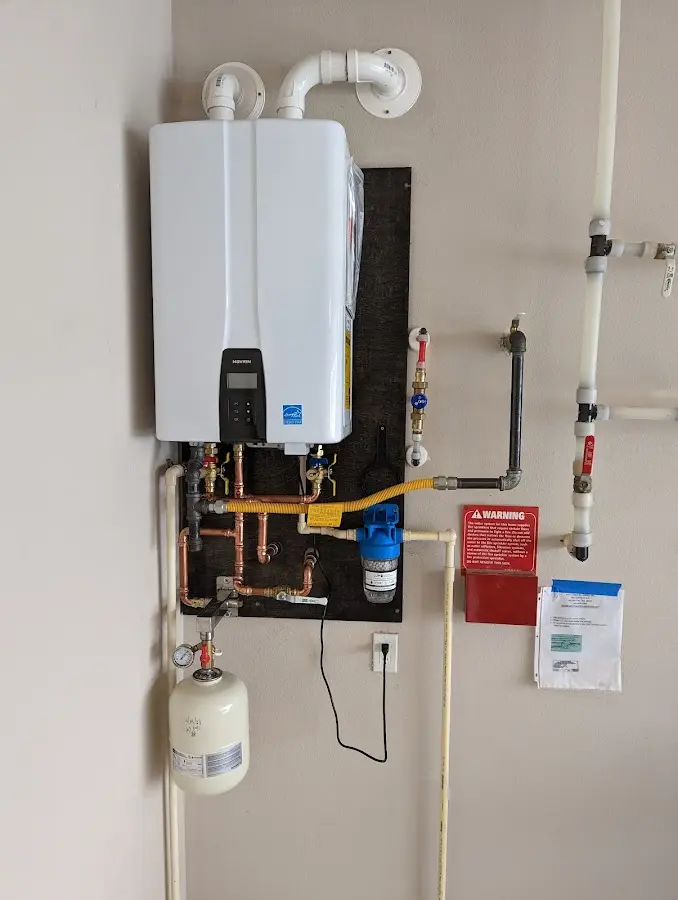 Professional plumber installing copper piping in a Grambling home